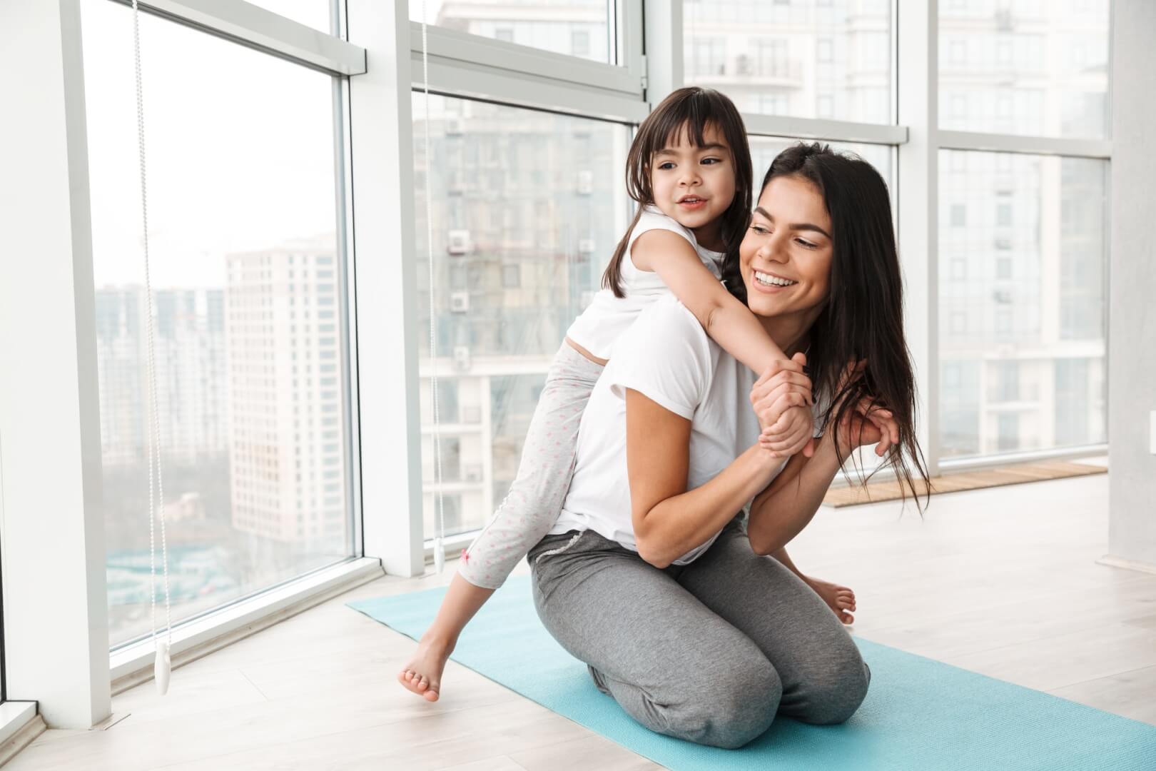 photo-of-caucasian-young-woman-and-her-girl-kid-playing-around-.jpg